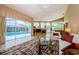 The living room offers natural light, access to the pool, and entertainment center with fireplace at 2042 Diamond Ct, Oldsmar, FL 34677
