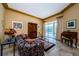 Cozy living room with sliding glass doors leading to a screened pool area at 2042 Diamond Ct, Oldsmar, FL 34677