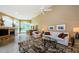 Spacious living room featuring a fireplace, wet bar, comfortable seating, and bright natural light at 2042 Diamond Ct, Oldsmar, FL 34677