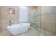 Relaxing main bathroom with a soaking tub and walk-in shower with glass enclosure at 2042 Diamond Ct, Oldsmar, FL 34677