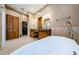 Large main bathroom with dual sinks, cabinets, soaking tub, and a walk-in shower at 2042 Diamond Ct, Oldsmar, FL 34677