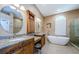 Spacious main bathroom featuring dual sinks, cabinets, soaking tub, and a walk-in shower at 2042 Diamond Ct, Oldsmar, FL 34677