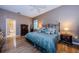 Comfortable main bedroom with hardwood floors, ceiling fan, and en suite bathroom at 2042 Diamond Ct, Oldsmar, FL 34677