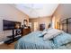 This main bedroom features a ceiling fan, hardwood floors, and an entertainment center at 2042 Diamond Ct, Oldsmar, FL 34677