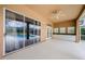 Covered patio featuring white cabinets with wet bar area and view of the screened in pool at 2042 Diamond Ct, Oldsmar, FL 34677