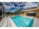 A screened pool with a spa provides a refreshing outdoor retreat at 2042 Diamond Ct, Oldsmar, FL 34677