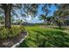 A grassy lawn surrounds fenced tennis courts at Ardea Country Club at 2042 Diamond Ct, Oldsmar, FL 34677