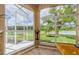 Picturesque view from the large window overlooking the green yard with palm trees and a pond at 2042 Diamond Ct, Oldsmar, FL 34677