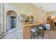 Wet bar including sink, wood countertops, and display shelves near a bathroom at 2042 Diamond Ct, Oldsmar, FL 34677