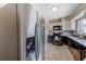 A well-appointed kitchen with black appliances, granite countertops, and stainless steel refrigerator at 2639 28Th N Ave, St Petersburg, FL 33713