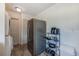 Functional laundry area with stainless steel refrigerator and shelving unit for convenient storage at 2639 28Th N Ave, St Petersburg, FL 33713