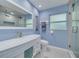 Bright bathroom featuring a modern vanity with ample storage and a glass-enclosed shower at 2671 Clubhouse N Dr, Clearwater, FL 33761