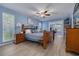 Spacious bedroom featuring blue walls, wood-look flooring, and a connected office area at 2671 Clubhouse N Dr, Clearwater, FL 33761