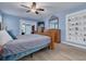 Tranquil bedroom featuring blue walls, wood-look flooring, and adjacent office space at 2671 Clubhouse N Dr, Clearwater, FL 33761
