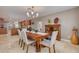 Open dining area showcases a classic wooden table and chairs adjacent to the kitchen at 2671 Clubhouse N Dr, Clearwater, FL 33761
