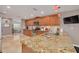 Spacious kitchen featuring granite countertops, stainless steel appliances, and eat-in breakfast bar at 2671 Clubhouse N Dr, Clearwater, FL 33761