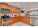 Well-appointed kitchen featuring stainless steel appliances and wood cabinetry at 2671 Clubhouse N Dr, Clearwater, FL 33761