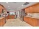 Open kitchen with stainless steel appliances, wooden cabinets, and ample counter space for cooking at 2671 Clubhouse N Dr, Clearwater, FL 33761