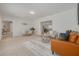 Open-concept living area with stylish furniture, including a brown leather couch and inviting dining space at 2671 Clubhouse N Dr, Clearwater, FL 33761