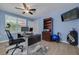 Functional office space with a ceiling fan, natural light, and a spacious desk at 2671 Clubhouse N Dr, Clearwater, FL 33761
