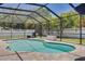 Screened-in pool area showcasing a swimming pool, brick pavers, privacy fence and manicured landscaping at 2671 Clubhouse N Dr, Clearwater, FL 33761