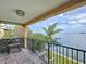 Enjoy scenic water views and outdoor grilling on this private balcony with a gas grill and black metal railing at 2675 St Josephs E Dr # C, Dunedin, FL 34698