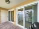 View of tiled balcony with sliding glass doors overlooking the water, perfect for relaxation at 2675 St Josephs E Dr # C, Dunedin, FL 34698