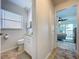 Powder room showing the commode, countertop, and a peek into the main bedroom at 2675 St Josephs E Dr # C, Dunedin, FL 34698