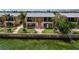 Beautiful waterfront property featuring green lawns, a well-maintained exterior, and lush landscaping at 2675 St Josephs E Dr # C, Dunedin, FL 34698