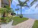 Waterfront home featuring lush landscaping and a pier at 2675 St Josephs E Dr # C, Dunedin, FL 34698