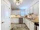 Beautiful kitchen with white cabinets, granite countertops, and stainless steel dishwasher and sink at 2675 St Josephs E Dr # C, Dunedin, FL 34698