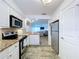 Bright kitchen with stainless steel appliances and granite countertops opens to living area at 2675 St Josephs E Dr # C, Dunedin, FL 34698