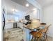 Bright kitchen featuring white cabinets, granite countertops, and stainless steel appliances at 2675 St Josephs E Dr # C, Dunedin, FL 34698