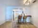 Kitchen view showing barstool seating, granite countertops, and stainless steel appliances at 2675 St Josephs E Dr # C, Dunedin, FL 34698