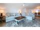 Inviting living room featuring plush sofas, ceiling fan and an inviting decor at 2675 St Josephs E Dr # C, Dunedin, FL 34698