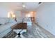 Inviting living room featuring comfortable seating, ceiling fan, and natural light at 2675 St Josephs E Dr # C, Dunedin, FL 34698