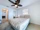 Bedroom featuring a ceiling fan, closet, hallway and ocean view at 2675 St Josephs E Dr # C, Dunedin, FL 34698