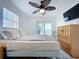 Cozy main bedroom with ceiling fan, balcony access, and water views at 2675 St Josephs E Dr # C, Dunedin, FL 34698
