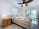 Bedroom with a sliding glass door to a balcony overlooking the ocean at 2675 St Josephs E Dr # C, Dunedin, FL 34698