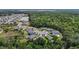 A panoramic aerial view of a neighborhood, pond and forest at 2821 Lytton Hall Dr, Zephyrhills, FL 33540