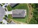 Aerial shot of a home with well-manicured lawn and a concrete patio with outdoor seating at 2821 Lytton Hall Dr, Zephyrhills, FL 33540