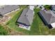 An aerial shot of a home with a patio and outdoor seating surrounded by lush green lawn at 2821 Lytton Hall Dr, Zephyrhills, FL 33540
