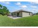 Spacious backyard features a well-manicured lawn, patio, and comfortable outdoor seating area at 2821 Lytton Hall Dr, Zephyrhills, FL 33540