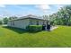 Expansive backyard features well-maintained lawn, patio, and barbecue area perfect for entertaining outdoors at 2821 Lytton Hall Dr, Zephyrhills, FL 33540