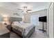 Bedroom featuring a queen bed, window with blinds, ceiling fan, and furnishings at 2821 Lytton Hall Dr, Zephyrhills, FL 33540