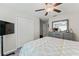 Bedroom featuring a queen bed, window with blinds, ceiling fan, closet, and furnishings at 2821 Lytton Hall Dr, Zephyrhills, FL 33540