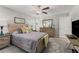 Comfortable bedroom with a wooden bed frame, dresser, and bedside table at 2821 Lytton Hall Dr, Zephyrhills, FL 33540