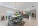 Open dining area flowing to living space with a sliding glass door to the backyard at 2821 Lytton Hall Dr, Zephyrhills, FL 33540