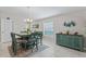 Dining room with a window, chandelier, and a blue cabinet and dining set at 2821 Lytton Hall Dr, Zephyrhills, FL 33540