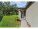 Inviting front door with sidelights and well manicured yard at 2821 Lytton Hall Dr, Zephyrhills, FL 33540
